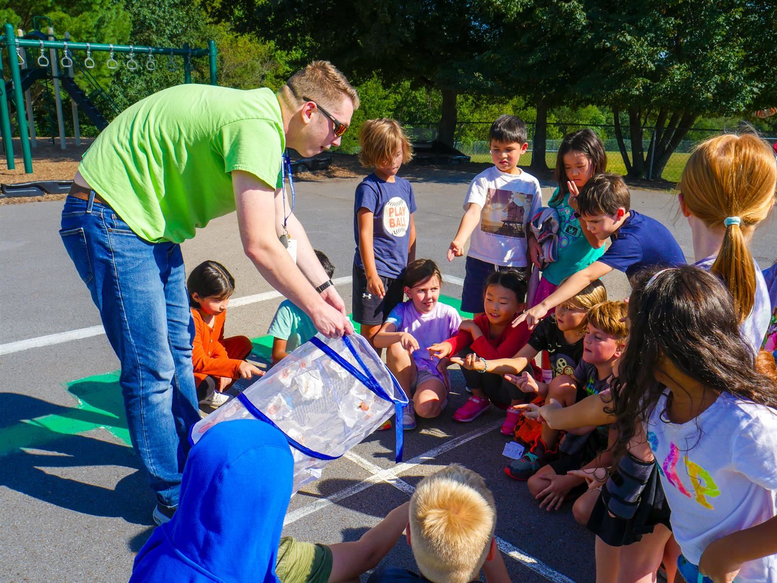 a teacher showing butterflies to kids